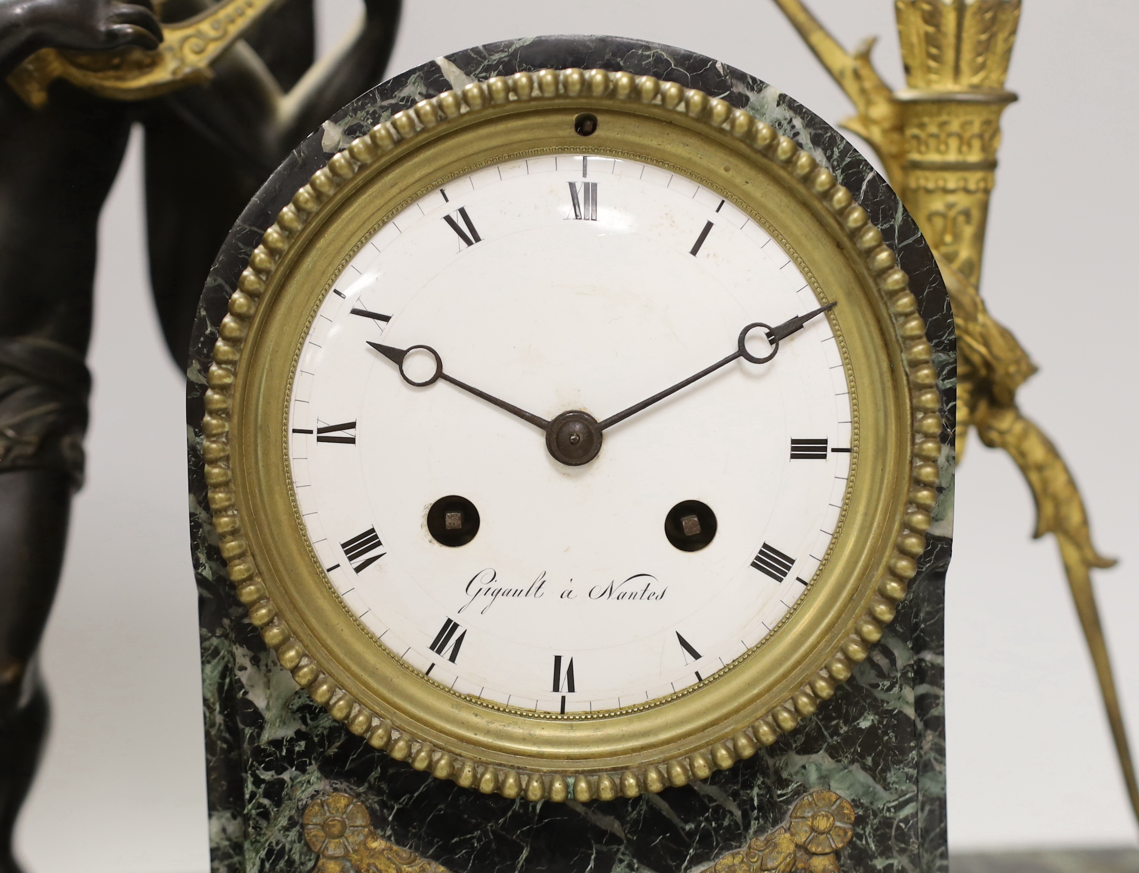 An early 19th century French ormolu and marble mantel clock in the form of Apollo, the enamel dial inscribed, Gigault A Nantes, 35cm high